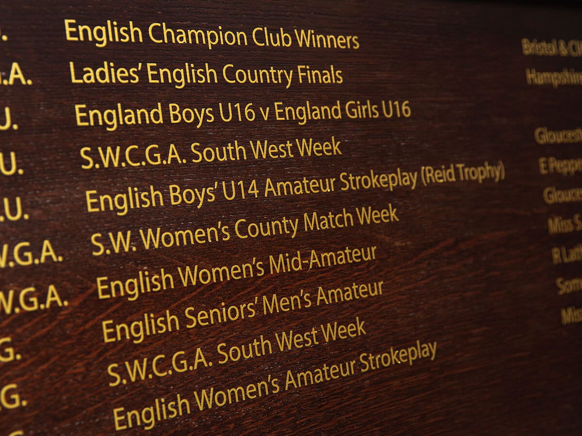 Gold Leaf lettering on a wooden honours board