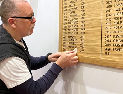An honours board being updated