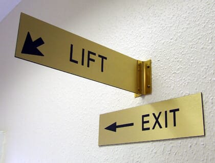Wall mounted projecting directional signs