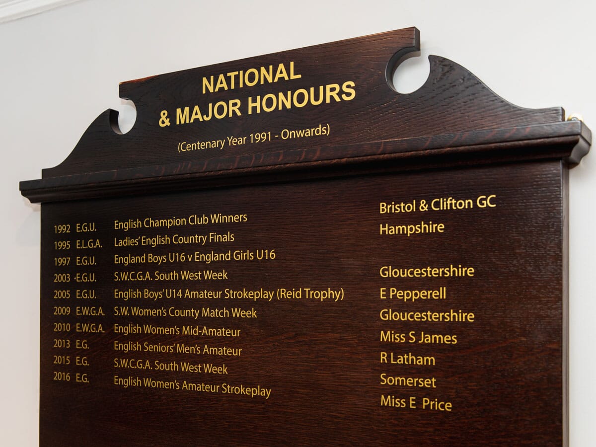 Dark wooden golf club honours board