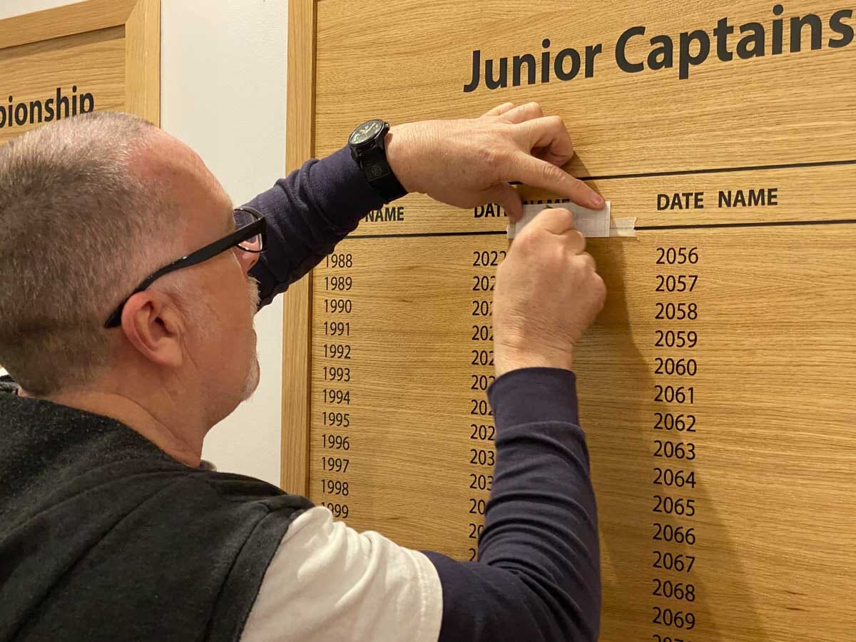 honours board lettering being applied