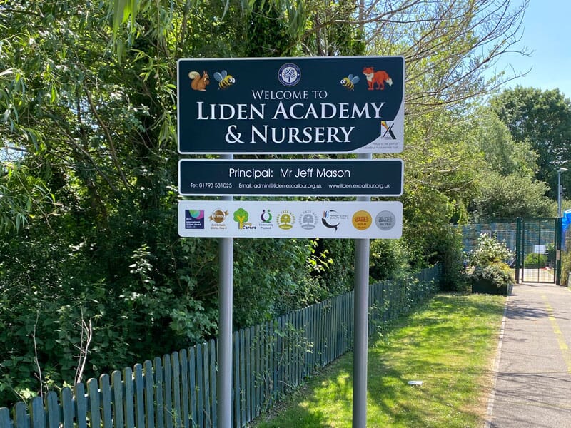 a school sign on posts